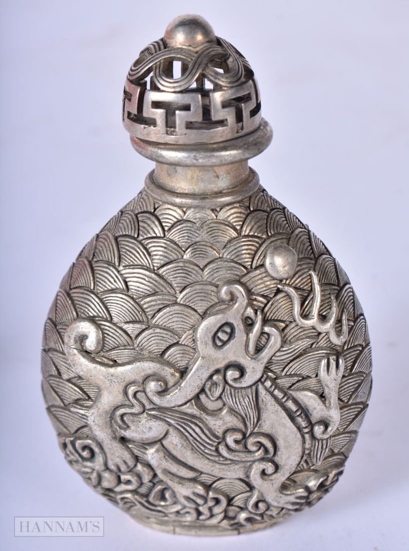 A Chinese white metal embossed dragon snuff bottle 9.1 x 5.8cm, wgt 136g: A Chinese white metal embossed dragon snuff bottle 9.1 x 5.8cm, wgt 136g