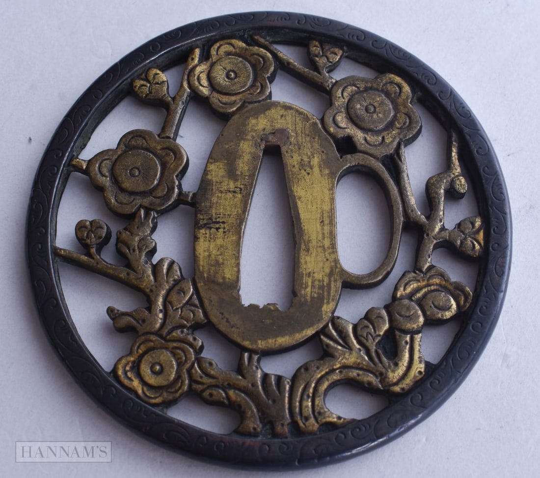 A 19TH CENTURY JAPANESE MEIJI PERIOD BRONZE TSUBA decorated with reticulated foliage. 7.5 cm x 7.5 c: A 19TH CENTURY JAPANESE MEIJI PERIOD BRONZE TSUBA decorated with reticulated foliage. 7.5 cm x 7.5 cm.