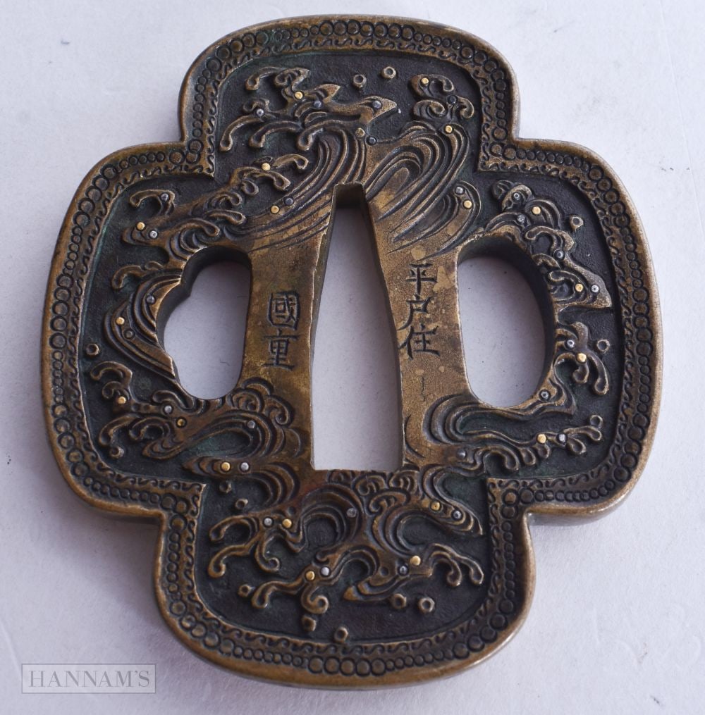 A 19TH CENTURY JAPANESE MEIJI PERIOD GOLD AND SILVER ONLAID DRAGON TSUBA modelled pursuing a flaming: A 19TH CENTURY JAPANESE MEIJI PERIOD GOLD AND SILVER ONLAID DRAGON TSUBA modelled pursuing a flaming pearl. 6.5 cm x 7 cm.