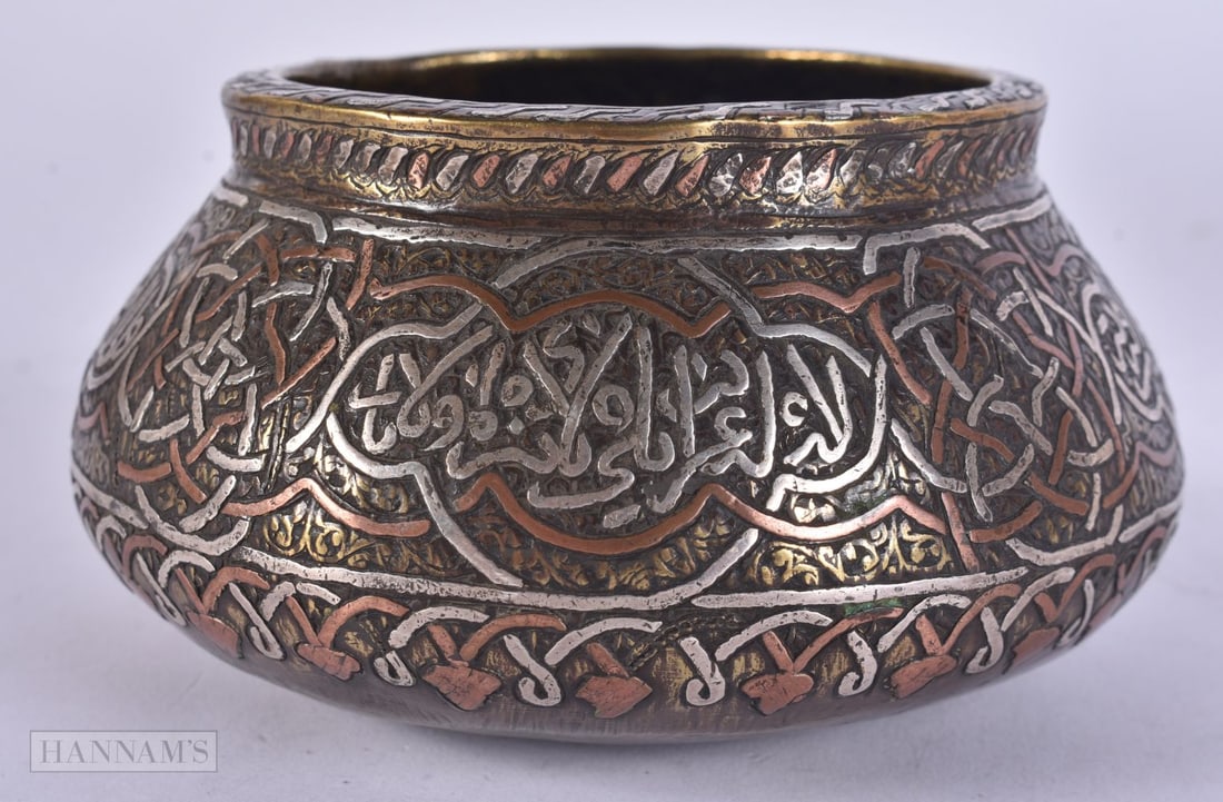 A 19TH CENTURY ISLAMIC MIDDLE EASTERN SILVER INLAID CENSER decorated with scripture. 12 cm wide. (1 of 4)