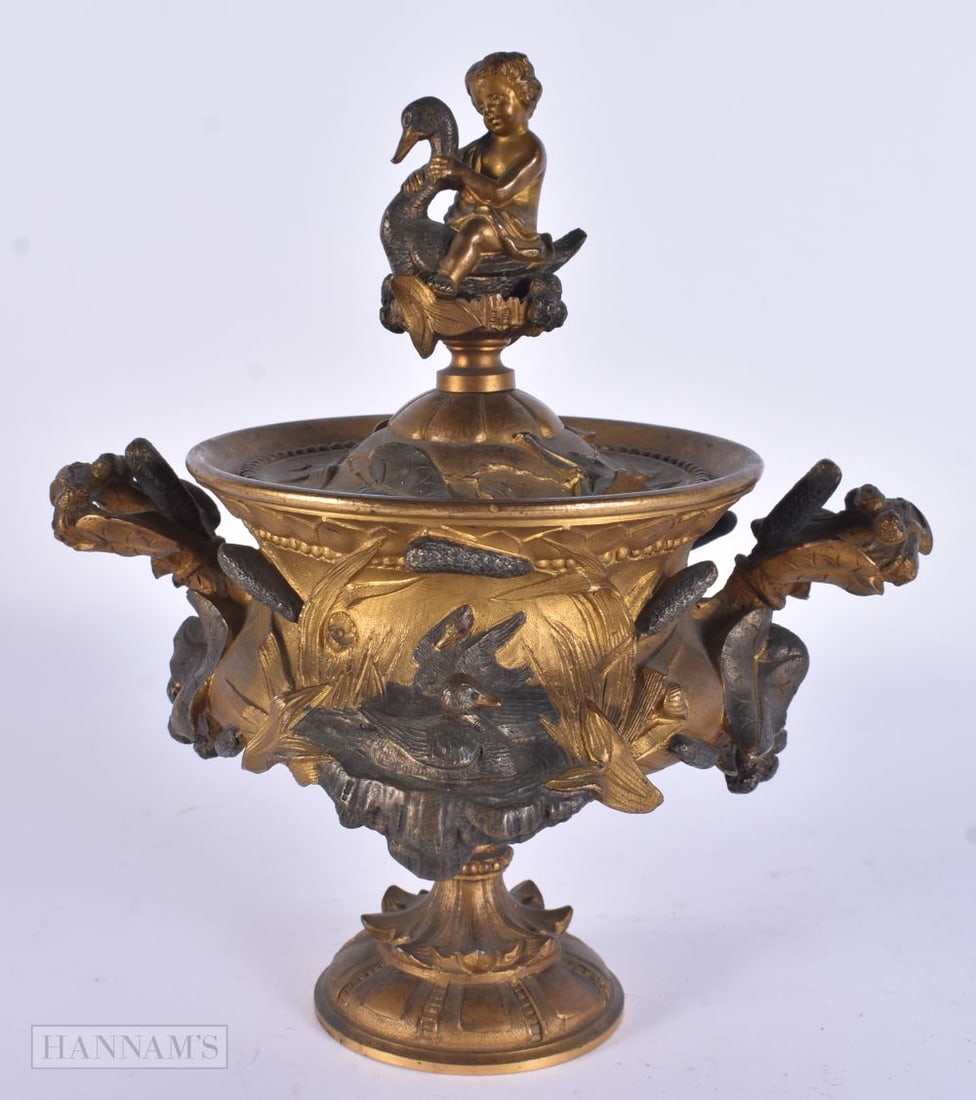 A 19TH CENTURY FRENCH GILT AND PARTIAL BRONZE VASE AND COVER surmounted with a figure riding a swan. (1 of 6)