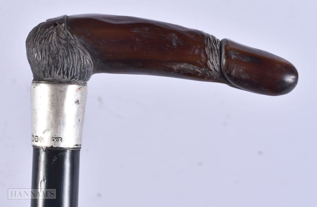 A VICTORIAN SILVER MOUNTED CARVED EROTIC PHALLUS HORN WALKING CANE. 83 cm long.: A VICTORIAN SILVER MOUNTED CARVED EROTIC PHALLUS HORN WALKING CANE. 83 cm long.