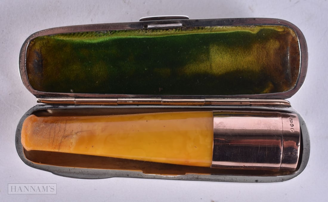 AN ANTIQUE SILVER CASED 9CT GOLD AND AMBER CHEROOT HOLDER. 53.9 grams. 9 cm long.: AN ANTIQUE SILVER CASED 9CT GOLD AND AMBER CHEROOT HOLDER. 53.9 grams. 9 cm long.