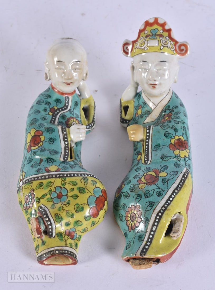 A PAIR OF EARLY 19TH CENTURY CHINESE PORCELAIN RECLINING FIGURES Jiaqing. 15cm wide.: A PAIR OF EARLY 19TH CENTURY CHINESE PORCELAIN RECLINING FIGURES Jiaqing. 15cm wide.