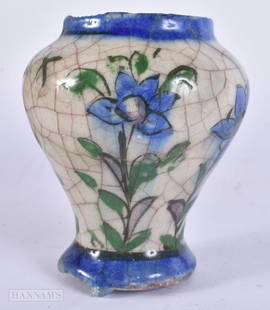 AN EARLY ISLAMIC PERSIAN QAJAR POTTERY VASE. 11 cm high.: AN EARLY ISLAMIC PERSIAN QAJAR POTTERY VASE. 11 cm high.