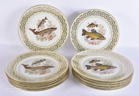 A LOVELY SET OF TWELVE FRENCH LIMOGES PORCELAIN FISH PLATES encased within a gilded ground. 26 cm di: A LOVELY SET OF TWELVE FRENCH LIMOGES PORCELAIN FISH PLATES encased within a gilded ground. 26 cm diameter. (12)