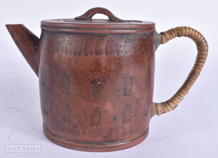 A CHINESE QING DYNASTY YIXING POTTERY TEAPOT AND COVER decorated with motifs. 17 cm wide.: A CHINESE QING DYNASTY YIXING POTTERY TEAPOT AND COVER decorated with motifs. 17 cm wide.