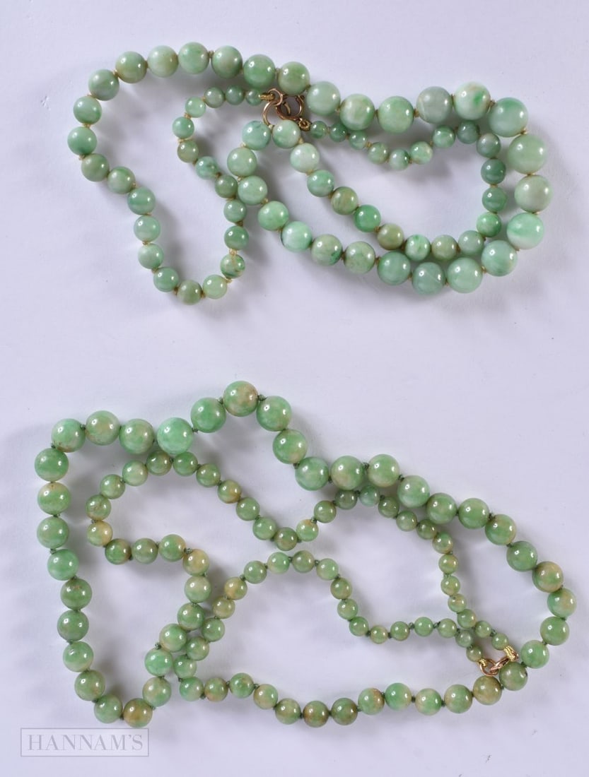 TWO EARLY 20TH CENTURY CHINESE CARVED JADEITE NECKLACES Late Qing/Republic. Largest 64 cm long. (2): TWO EARLY 20TH CENTURY CHINESE CARVED JADEITE NECKLACES Late Qing/Republic. Largest 64 cm long. (2)