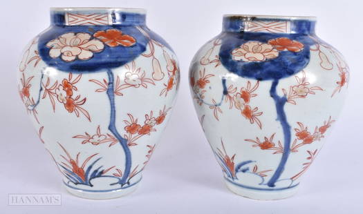 A PAIR OF 17TH/18TH CENTURY JAPANESE EDO PERIOD IMARI VASES painted with flowers. 18 cm high.: A PAIR OF 17TH/18TH CENTURY JAPANESE EDO PERIOD IMARI VASES painted with flowers. 18 cm high.