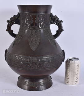 A LARGE EARLY 19TH CENTURY CHINESE TWIN HANDLED BRONZE VASE Qing, decorated with archaic mask heads.: A LARGE EARLY 19TH CENTURY CHINESE TWIN HANDLED BRONZE VASE Qing, decorated with archaic mask heads. 34 cm x 24 cm.