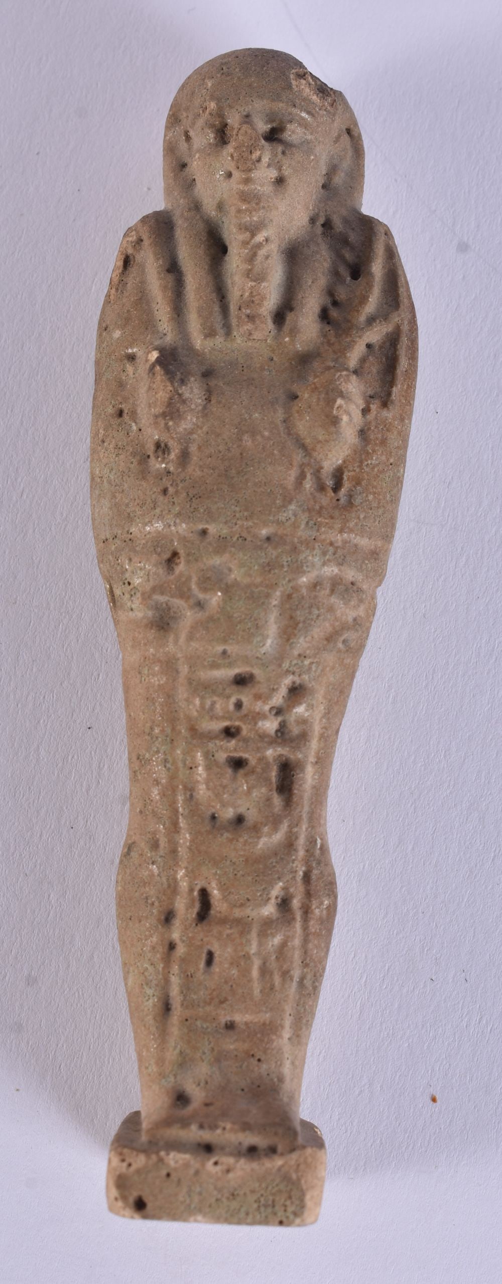 AN EARLY EGYPTIAN CARVED FAIENCE USHABTI. 10.25cm high. (1 of 6)