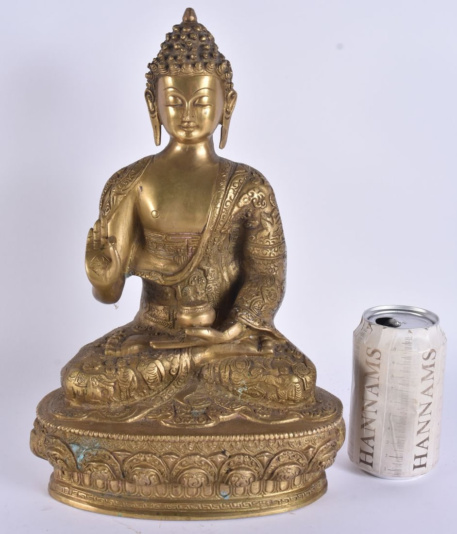A LARGE 19TH CENTURY INDIAN BRONZE FIGURE OF A SEATED BUDDHA modelled in high embellished robes. 33: A LARGE 19TH CENTURY INDIAN BRONZE FIGURE OF A SEATED BUDDHA modelled in high embellished robes. 33 cm x 18 cm.