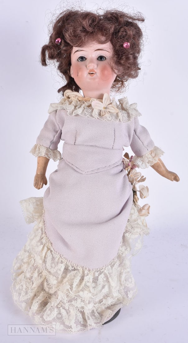 A GERMAN BISQUE HEADED PORCELAIN DOLL. 32 cm high.: A GERMAN BISQUE HEADED PORCELAIN DOLL. 32 cm high.