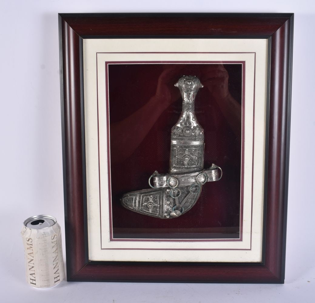 A CASED OMANI JAMBIYA SILVER OVERLAID DAGGER. 44 cm x 36 cm. (1 of 5)