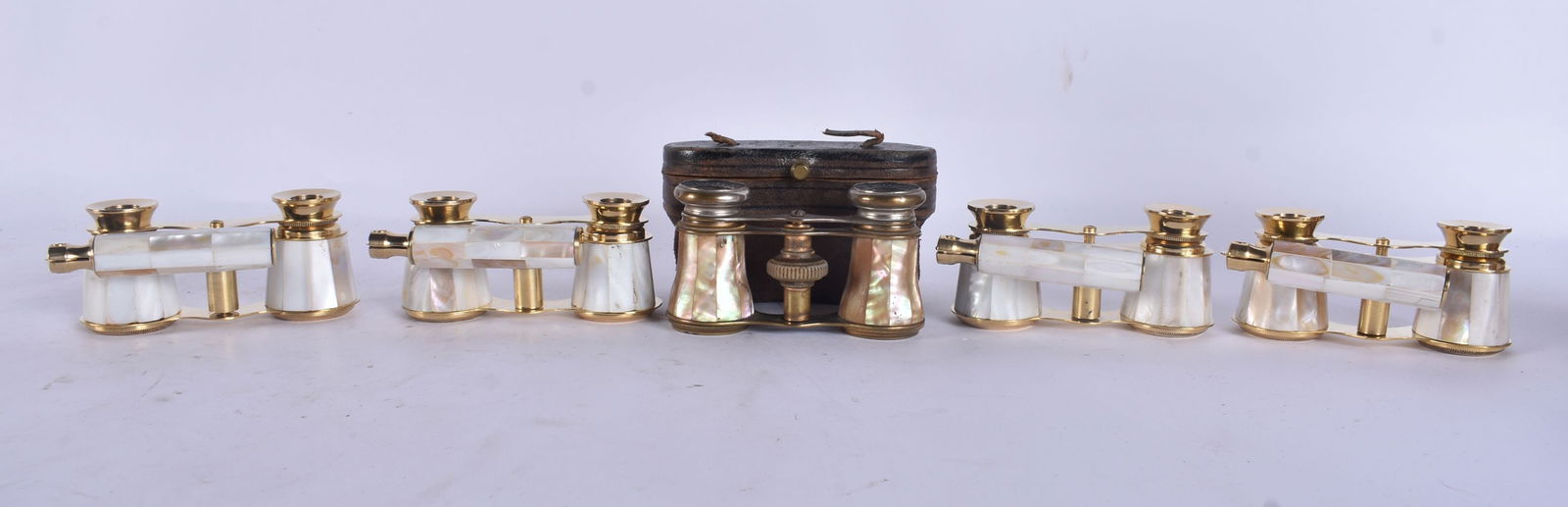 A PAIR OF ANTIQUE MOTHER OF PEARL OPERA GLASSES together with four other pairs of mother pearl opera: A PAIR OF ANTIQUE MOTHER OF PEARL OPERA GLASSES together with four other pairs of mother pearl opera glasses. Largest 18 cm long extended. (5)