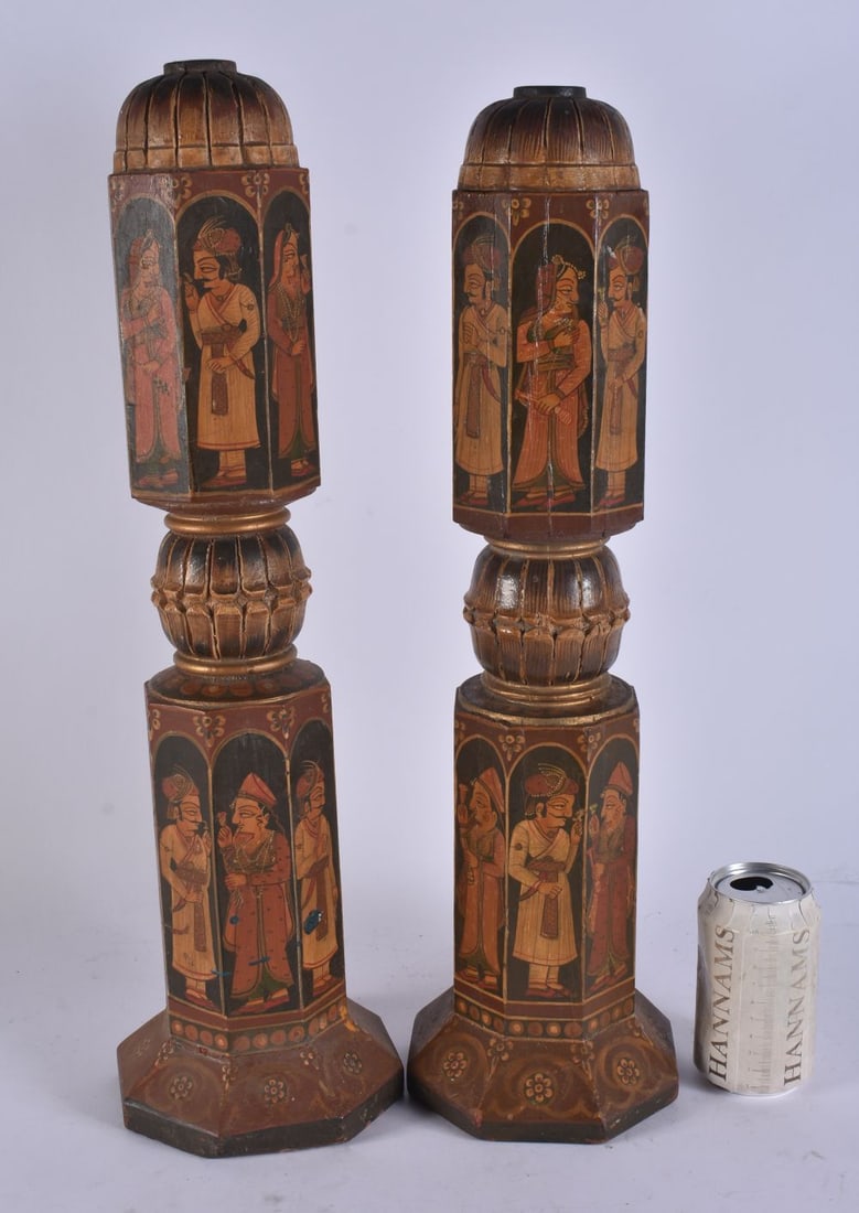 A CHARMING PAIR OF ANTIQUE INDIAN COUNTRY HOUSE WOOD LAMP BASES painted with figures and foliage. 50: A CHARMING PAIR OF ANTIQUE INDIAN COUNTRY HOUSE WOOD LAMP BASES painted with figures and foliage. 50 cm high.