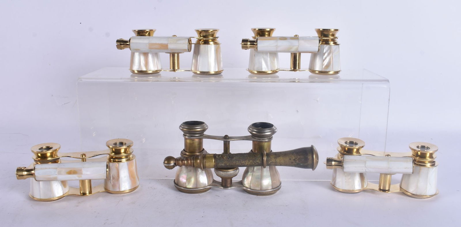 FIVE PAIRS OF MOTHER OF PEARL OPERA GLASSES. Largest 18 cm wide. (5): FIVE PAIRS OF MOTHER OF PEARL OPERA GLASSES. Largest 18 cm wide. (5)