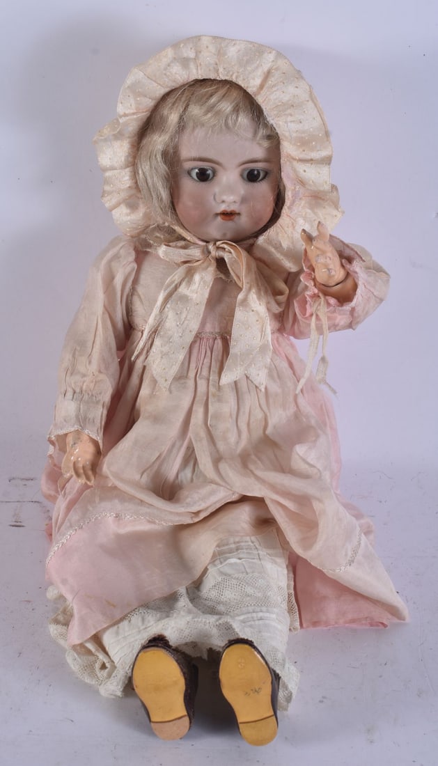 AN ANTIQUE BISQUE HEADED DOLL. 38 cm long.: AN ANTIQUE BISQUE HEADED DOLL. 38 cm long.