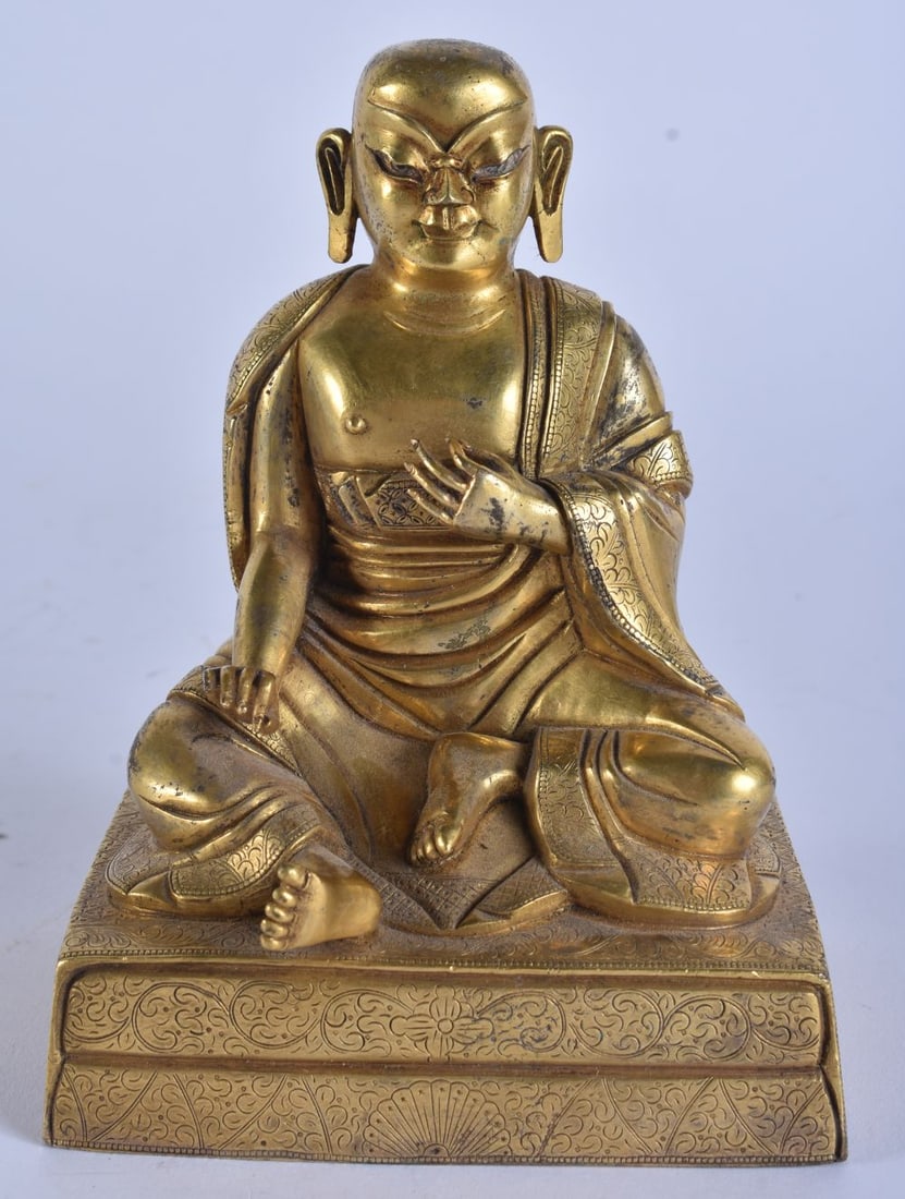 A GOOD CHINESE GILT BRONZE FIGURE OF A SEATED BUDDHA possibly 18th century, modelled upon a finely i: A GOOD CHINESE GILT BRONZE FIGURE OF A SEATED BUDDHA possibly 18th century, modelled upon a finely incised floral embellished base. 15cm x 9.5 cm.