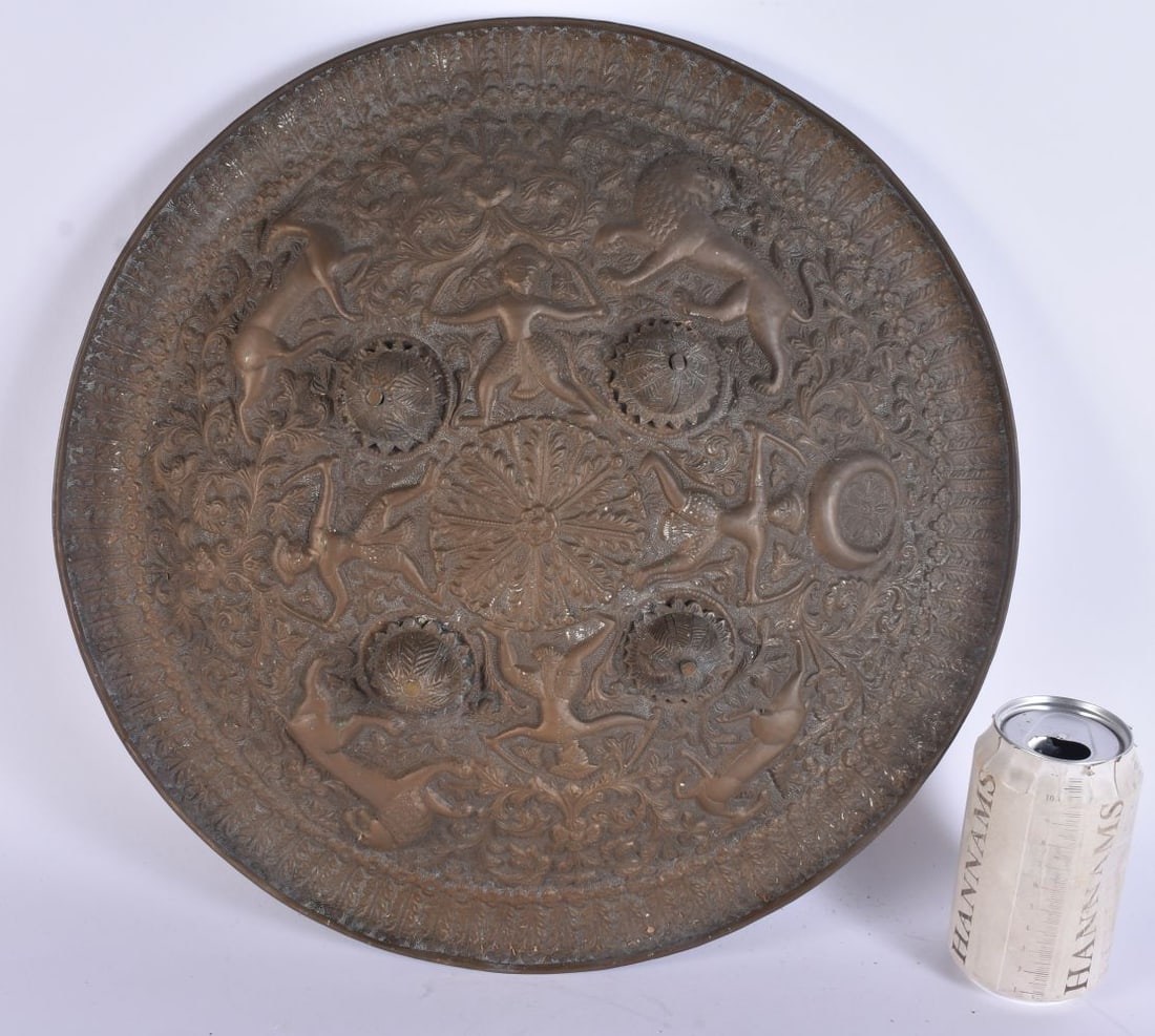 A 19TH CENTURY MIDDLE EASTERN INDIAN BRONZE SHIELD decorated in relief with figures and animals amon (1 of 5)