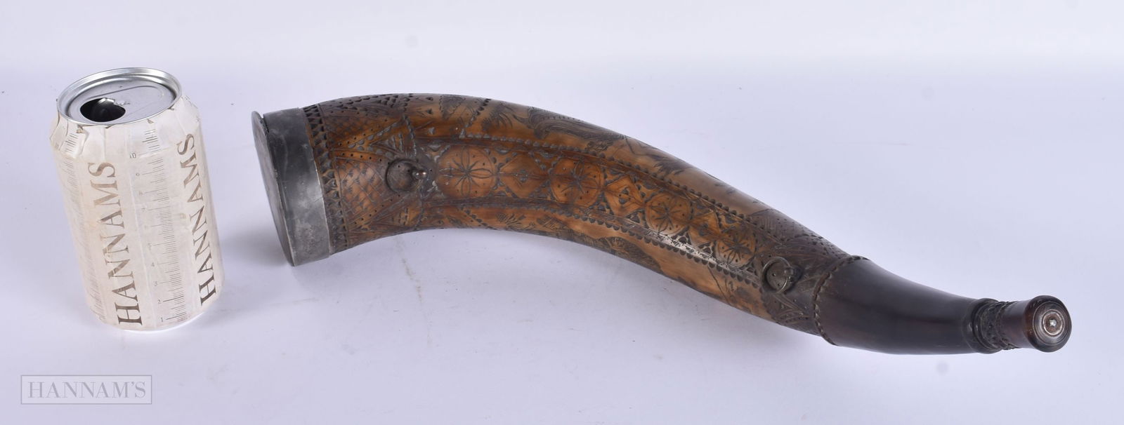 AN UNUSUAL EARLY 19TH CENTURY SCOTTISH CARVED SCRIMSHAW POWDER FLASK decorated with highland figures: AN UNUSUAL EARLY 19TH CENTURY SCOTTISH CARVED SCRIMSHAW POWDER FLASK decorated with highland figures and buildings within landscapes. 40 cm long.