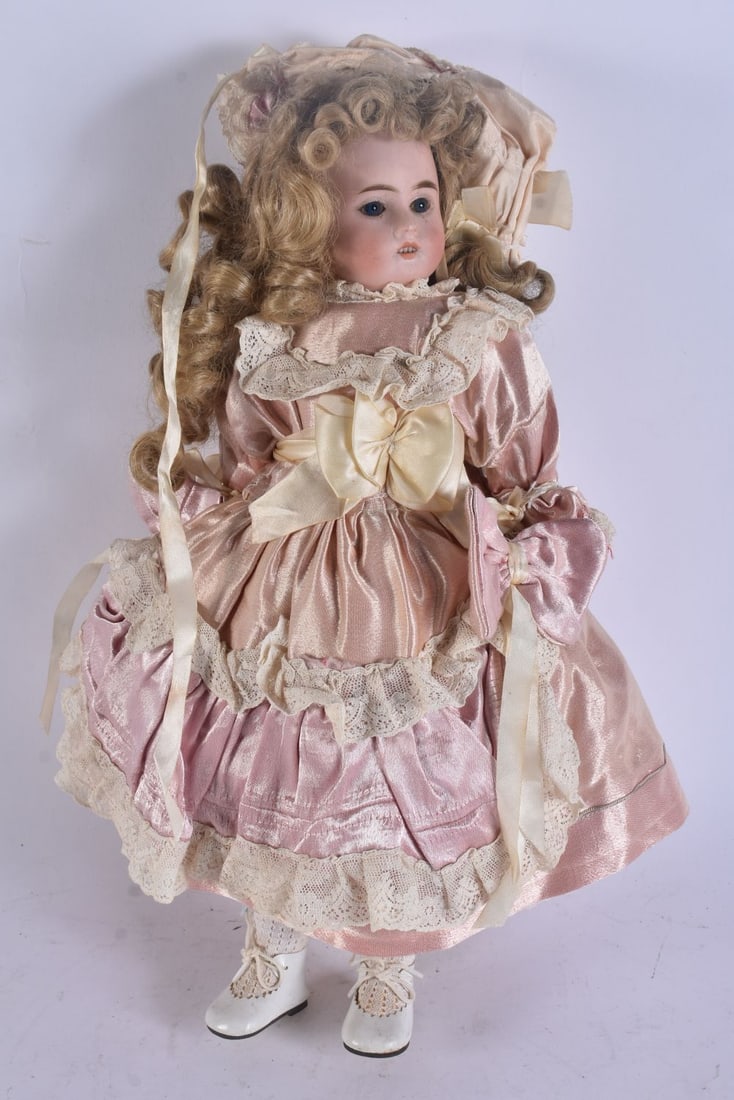 AN ANTIQUE PORCELAIN BISQUE HEADED DOLL. 42 cm long.: AN ANTIQUE PORCELAIN BISQUE HEADED DOLL. 42 cm long.