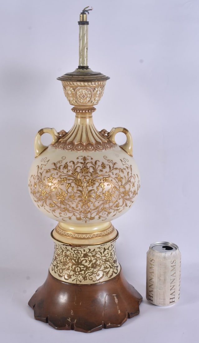 A LARGE 19TH CENTURY TWIN HANDLED BLUSH IVORY PORCELAIN LAMP richly gilded in relief with foliage. 5: A LARGE 19TH CENTURY TWIN HANDLED BLUSH IVORY PORCELAIN LAMP richly gilded in relief with foliage. 53 cm high.