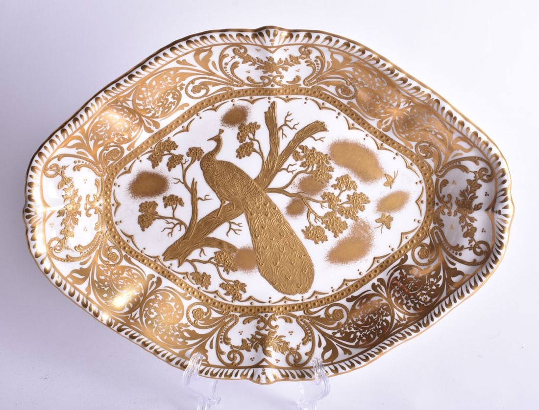 Derby oval dish highly gilded with birds and trees in the Aves pattern by Harry Sampson Hancock, sig: Derby oval dish highly gilded with birds and trees in the Aves pattern by Harry Sampson Hancock, signed verso,1930?s or earlier. 28cm wide