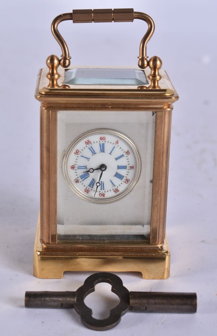 A MINIATURE SILVERED DIAL CARRIAGE CLOCK. 7 cm high inc handle.: A MINIATURE SILVERED DIAL CARRIAGE CLOCK. 7 cm high inc handle.
