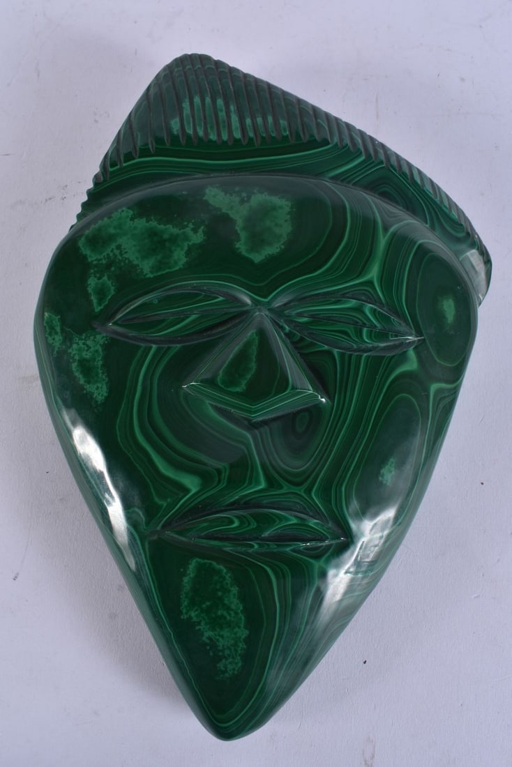 A CARVED MALACHITE TRIBAL MASK. 26 cm x 18 cm.: A CARVED MALACHITE TRIBAL MASK. 26 cm x 18 cm.