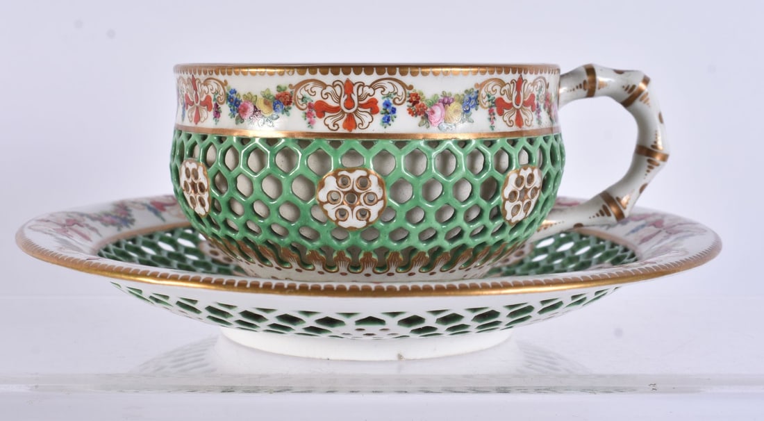 A LOVELY 19TH CENTURY WORCESTER RETICULATED CUP AND SAUCER painted with flowers. 13 cm wide. (2) (1 of 3)