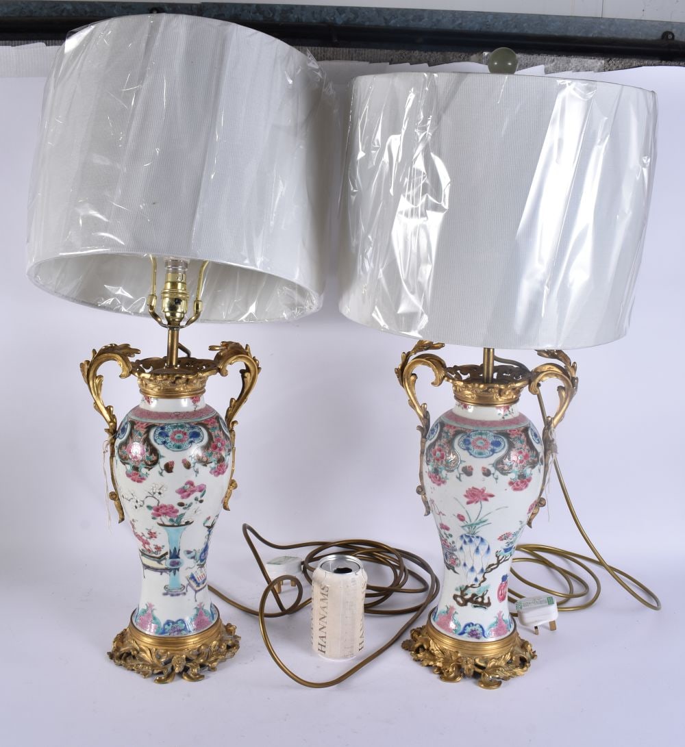 A FINE LARGE PAIR OF 18TH CENTURY CHINESE EXPORT FAMILLE ROSE LAMPS mounted in 19th century French o: A FINE LARGE PAIR OF 18TH CENTURY CHINESE EXPORT FAMILLE ROSE LAMPS mounted in 19th century French ormolu. 60 cm high.