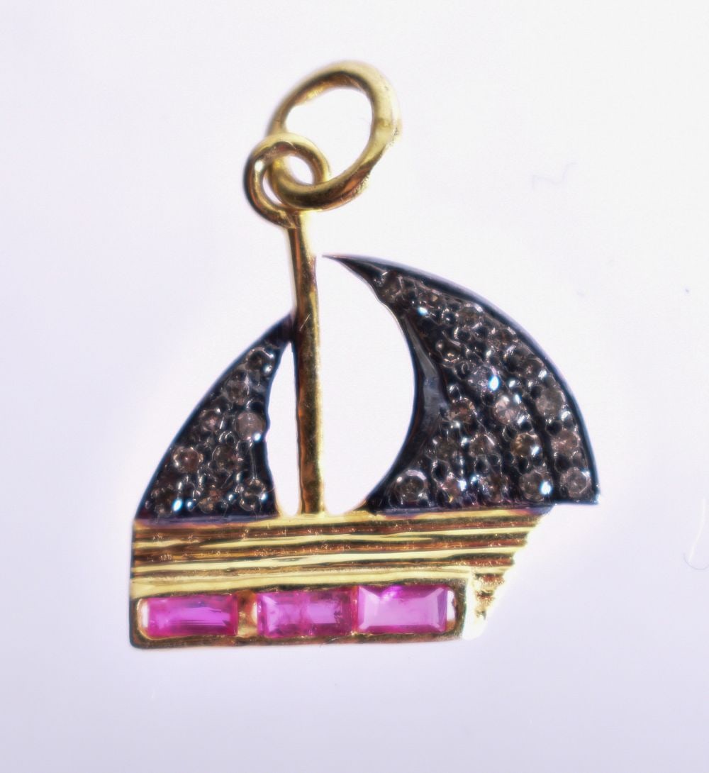 A Diamond Chip and Ruby Sailing Ship Pendant. 1.6cm x 1.8cm, weight 1.3g: A Diamond Chip and Ruby Sailing Ship Pendant. 1.6cm x 1.8cm, weight 1.3g
