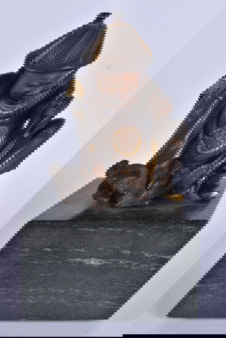 A 19TH CENTURY JAPANESE MEIJI PERIOD BRONZE OKIMONO by Miyao, modelled playing with a puppy upon a m