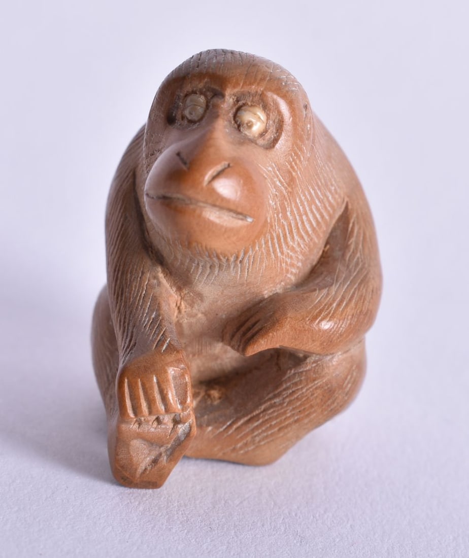 A JAPANESE TAISHO PERIOD WOOD MONKEY. 6.6 grams. 3 cm x 2.75 cm. (1 of 4)