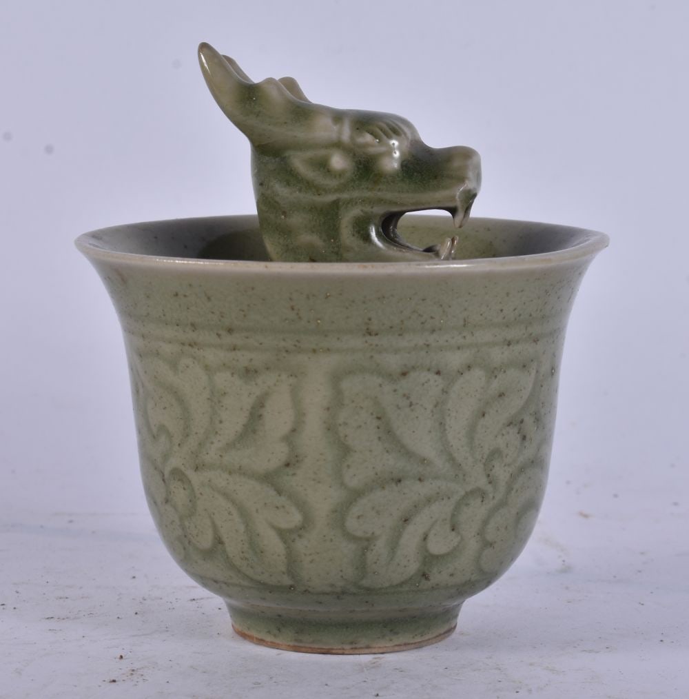 A CHINESE CELADON SURPRISE TEABOWL. 8.25 cm wide.: A CHINESE CELADON SURPRISE TEABOWL. 8.25 cm wide.
