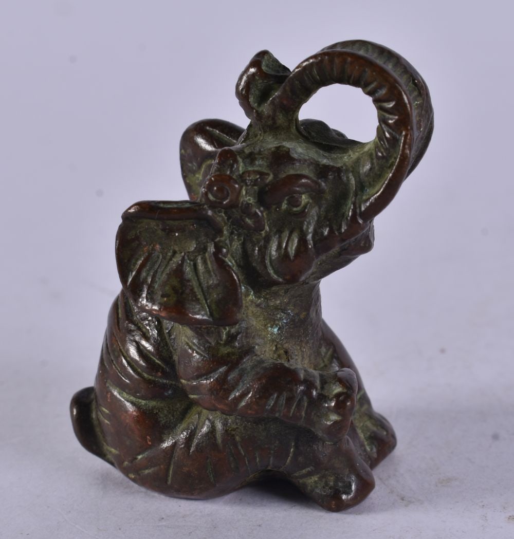 A Seated Bronze Elephant with Trunk Raised. 4.9cm x 3.5cm x 3.5cm, weight 141g: A Seated Bronze Elephant with Trunk Raised. 4.9cm x 3.5cm x 3.5cm, weight 141g