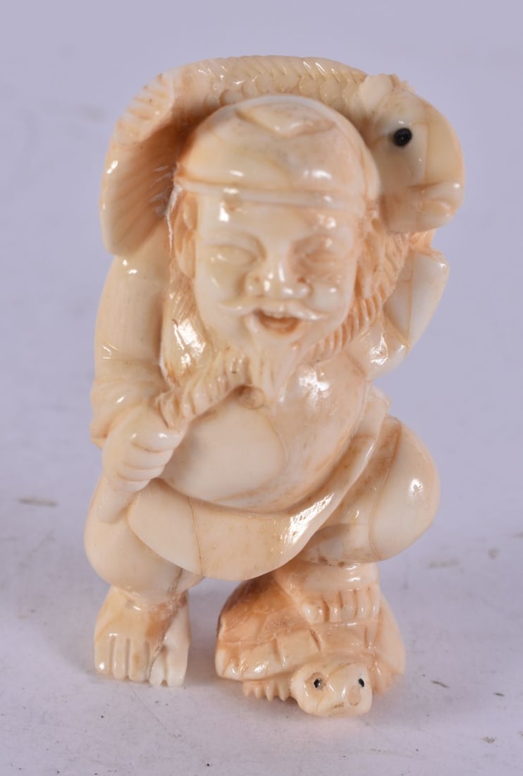 A Carved Figure of a Man Carrying a Fish. 5.1cm x 2.7cm x 2.3cm, weight 31g: A Carved Figure of a Man Carrying a Fish. 5.1cm x 2.7cm x 2.3cm, weight 31g