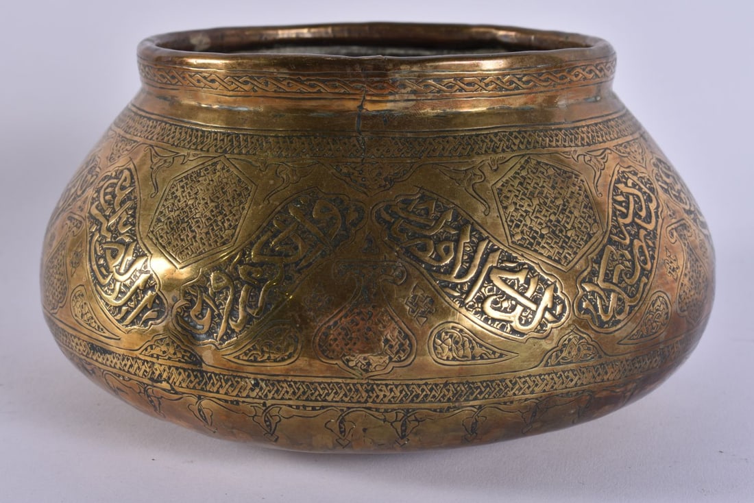 A 19TH CENTURY ISLAMIC MIDDLE EASTERN BRASS CENSER decorated with Kufic script. 18 cm wide. (1 of 5)
