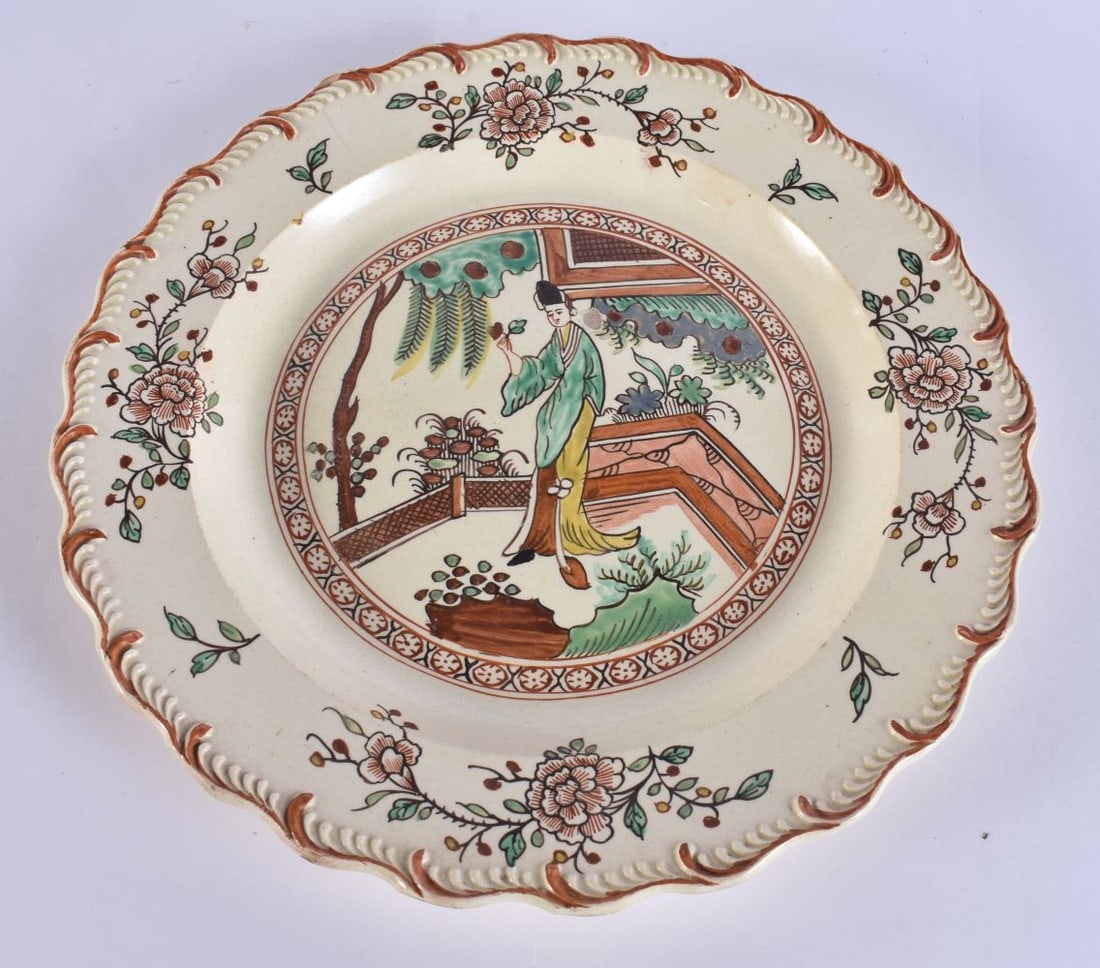 A LATE 18TH/19TH CENTURY ENGLISH CREAMWARE SCALLOPED PLATE painted with an Oriental figure holding a (1 of 6)