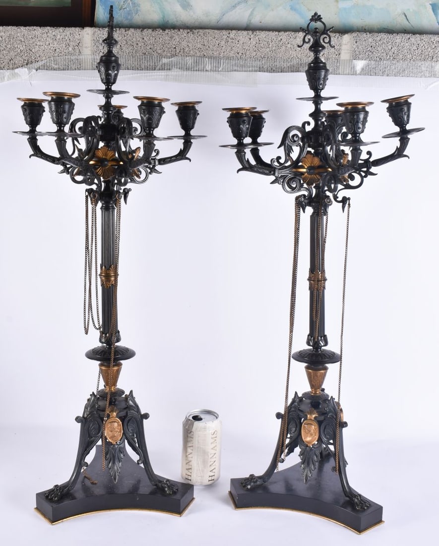 A LARGE PAIR OF 19TH CENTURY FRENCH BRONZE AND GILT BRONZE CANDLESTICKS formed with classical mask h (1 of 5)