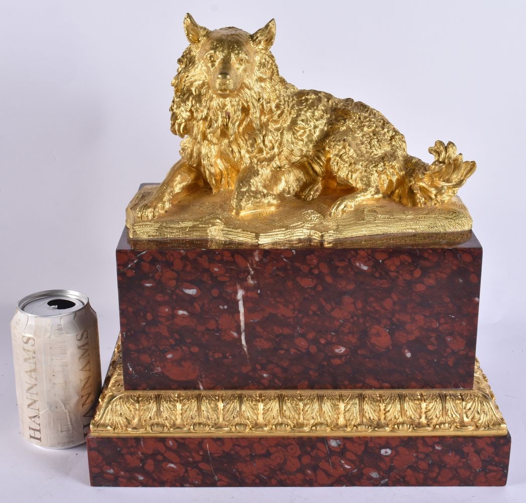 A LARGE 19TH CENTURY GILT BRONZE AND RED MARBLE FIGURE OF A HOUND modelled recumbent. 34 cm x 29 cm.: A LARGE 19TH CENTURY GILT BRONZE AND RED MARBLE FIGURE OF A HOUND modelled recumbent. 34 cm x 29 cm.