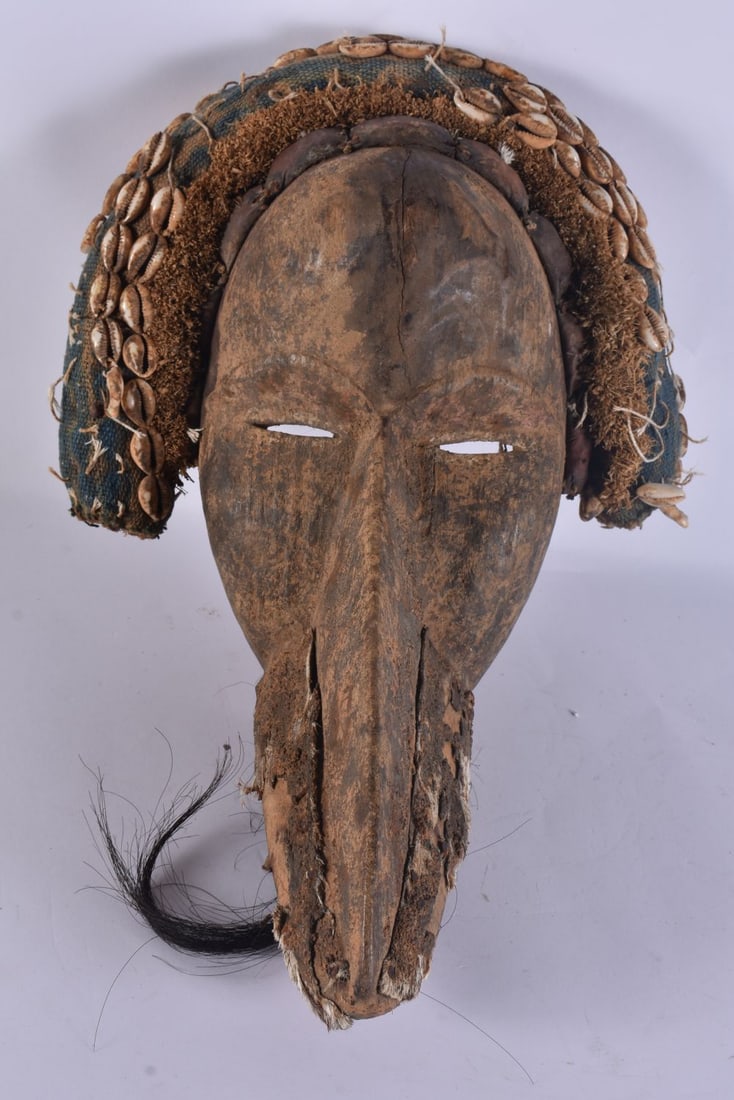 AN AFRICAN TRIBAL CONCH SHELL MASK. 35 cm x 24 cm. (1 of 5)