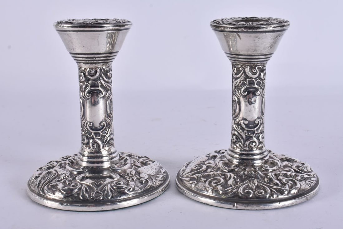 A PAIR OF SILVER CANDLESTICKS. 310 grams overall. 10.5 cm high. (1 of 5)