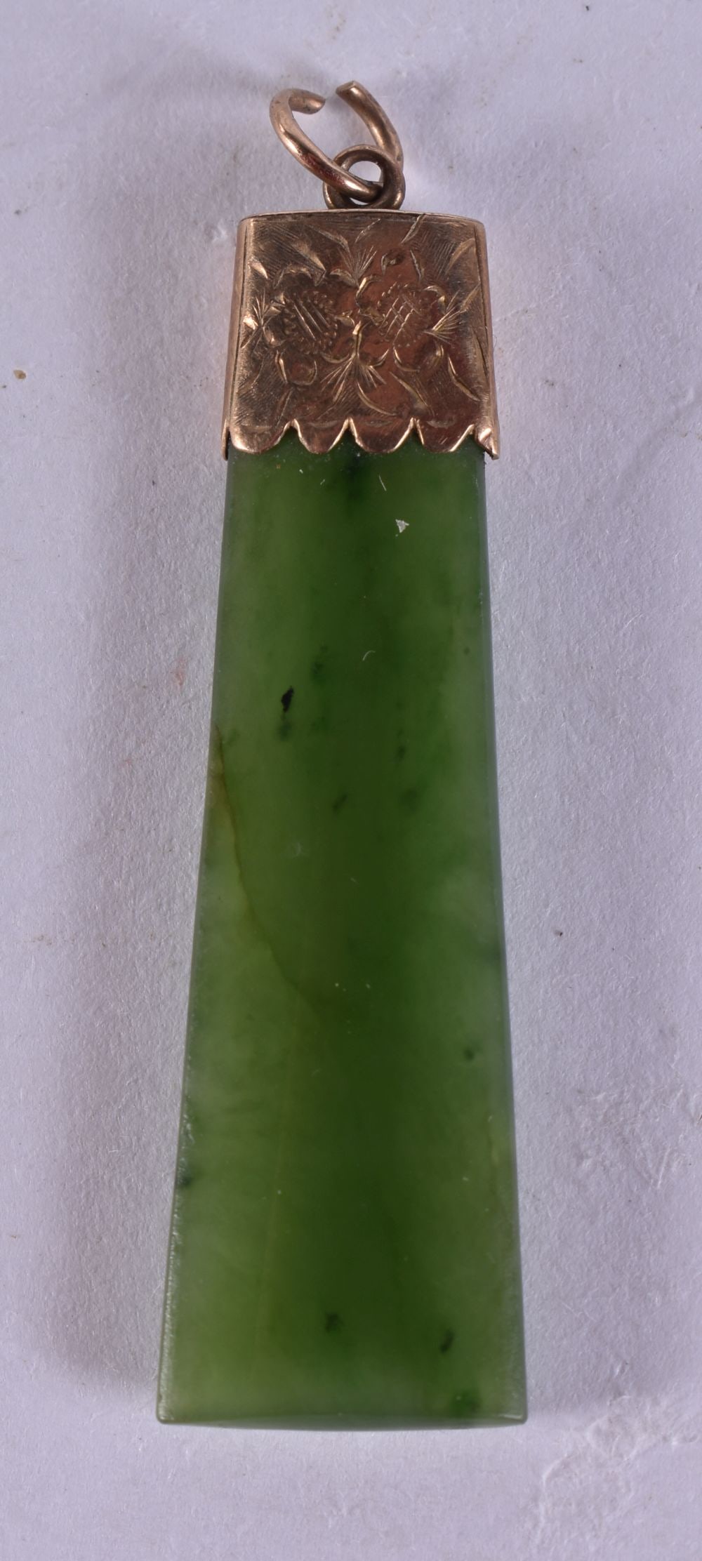 A 9CT GOLD MOUNTED JADE PENDANT. 5 grams. 4.75 cm x 1.25 cm. (1 of 3)