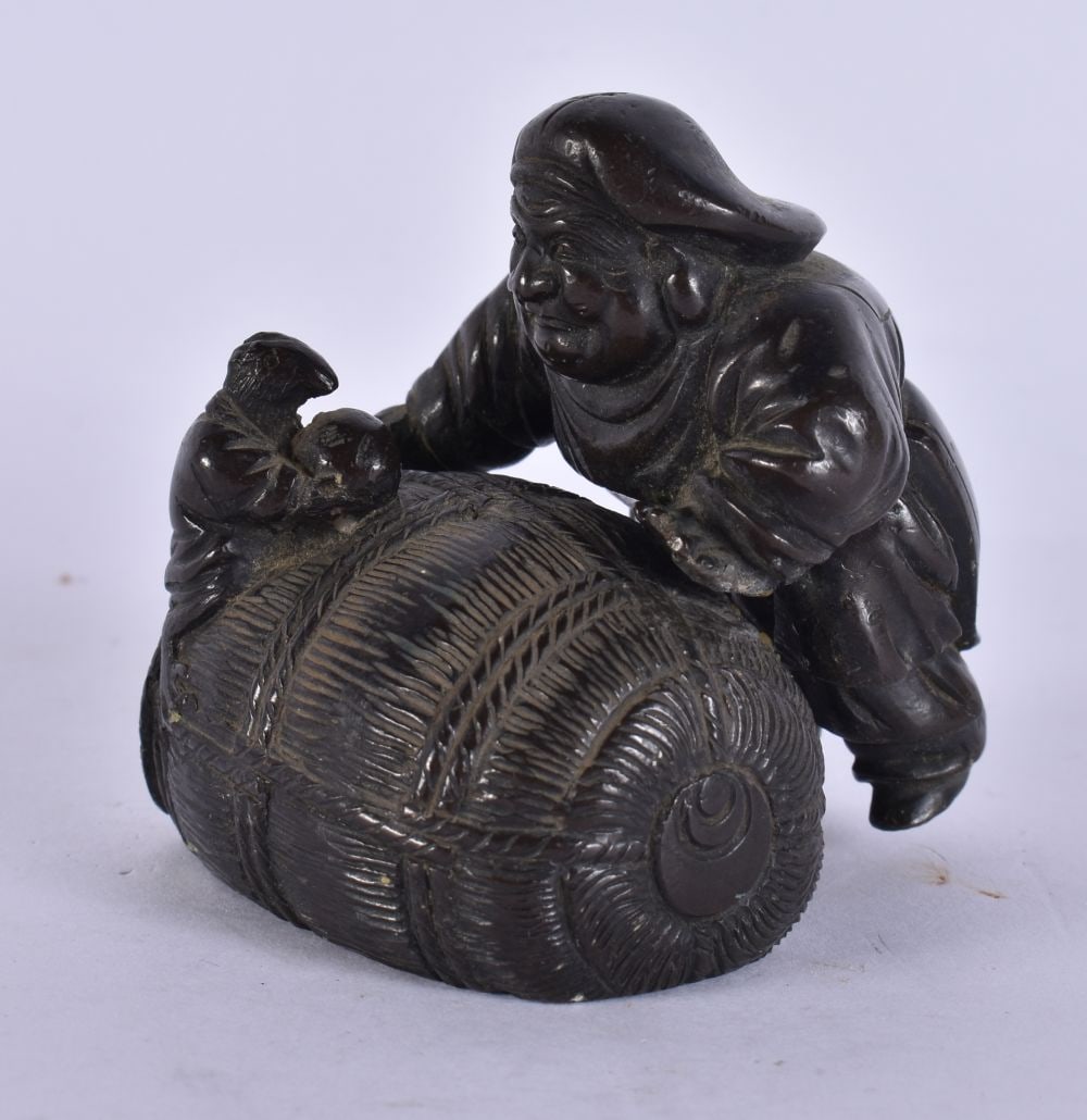 A 19TH CENTURY JAPANESE MEIJI PERIOD BRONZE OKIMONO modelled resting on a bail. 7.5 cm x 5.5 cm. (1 of 3)