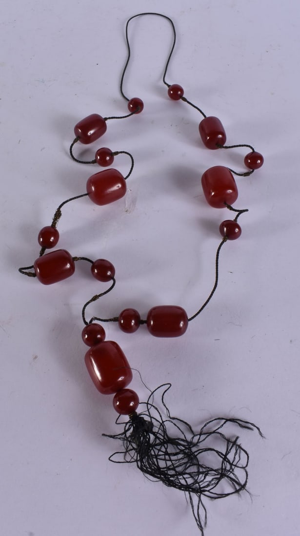 A FINE ART DECO CHERRY BAKELITE BEAD NECKLACE. 77 grams. 108 cm long, largest bead 2.75 cm x 2 cm. (1 of 7)