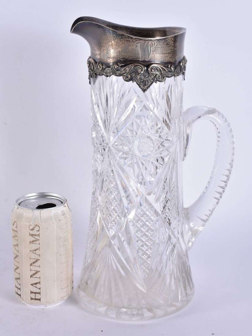 A LARGE SILVER MOUNTED CUT GLASS JUG. 30 cm high. (1 of 6)