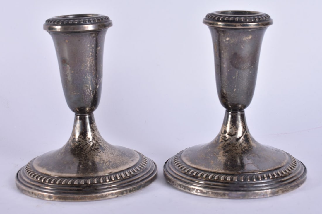 A PAIR OF SILVER CANDLESTICKS. 700 grams overall. 12 cm high. (1 of 4)