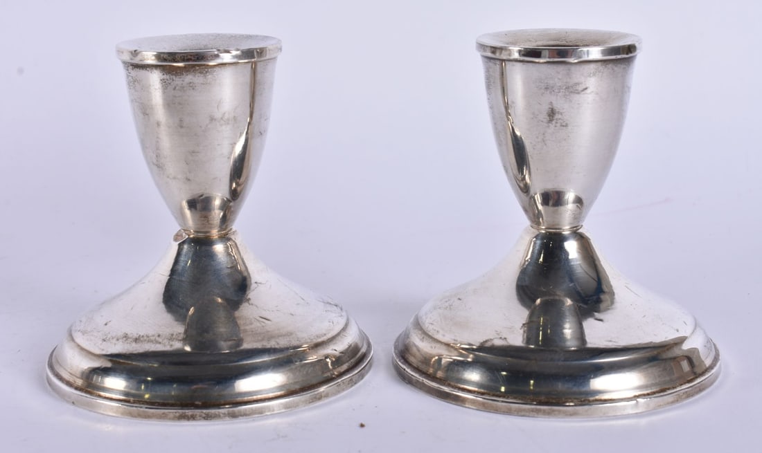 A PAIR OF SILVER CANDLESTICKS. 360 grams overall. 9.5 cm high. (1 of 5)
